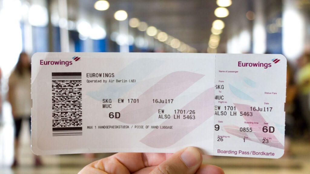 Traveller holding a boarding pass at an airport terminal, ready for international travel
